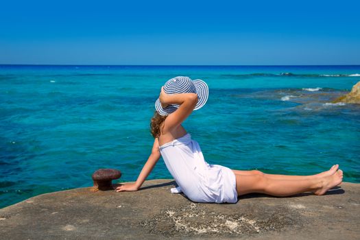 Girl looking at beach in Formentera turquoise Mediterranean sea background