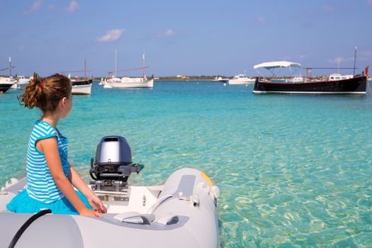 Kid girl in inflatable boat at formentera Estany des Peix near Ibiza