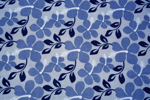 Blue flowers and navy blue leaves on a textil background