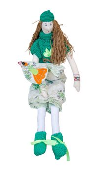 The Handmade doll with a bird on the hand in a dress and sweatersitting isolated