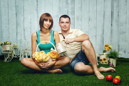 Young, happy married couple relaxing on the lawn and enjoys