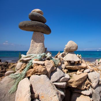 Stone figures on beach shore of Illetes beach in Formentera Mediterranean Balearic Islands