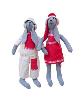 The Isolated handmade dolls bunny family in homespun clothing
