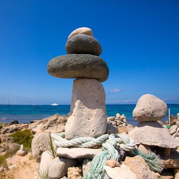 Stone figures on beach shore of Illetes beach in Formentera Mediterranean Balearic Islands