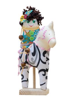 The Hand made soft toys girl cheerful characters on horseback isolated