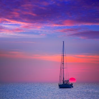 Ibiza sunset sun view from formentera Island with sailboat in Balearic Islands