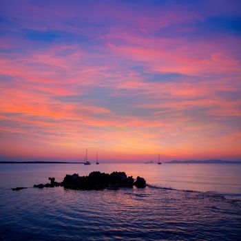 Ibiza sunset view from formentera Island with sailboat in Balearic Islands