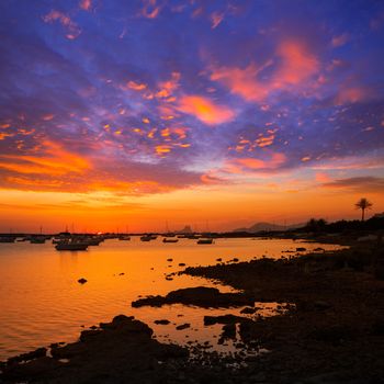 Formentera sunset in Estany des Peix boats with Ibiza Es vedra in Background