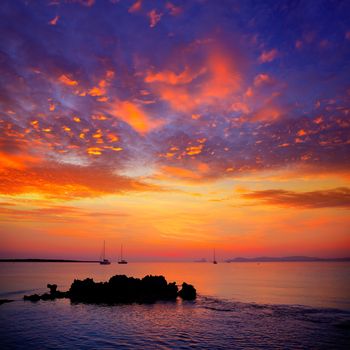 Ibiza sunset view from formentera Island with sailboat in Balearic Islands