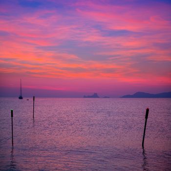 Ibiza sunset view from formentera Island with sailboat in Balearic Islands