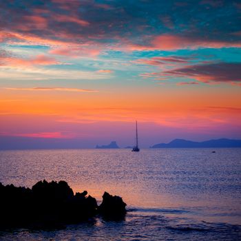 Ibiza sunset view from formentera Island with sailboat in Balearic Islands