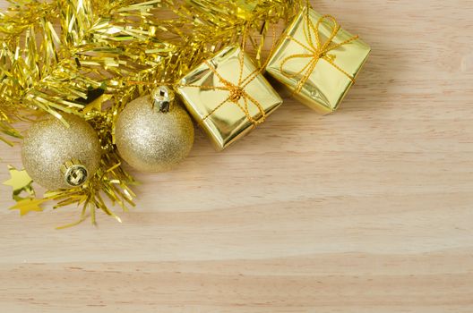 Gold Christmas bauble and Two Present Boxes on Wood Table Top View Background