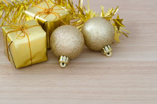 Gold Christmas bauble and Two Present Boxes on Wood Table Front View Background