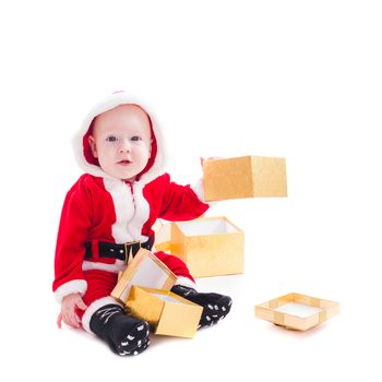 Little Santa boy with gold gift boxes isolated on white background