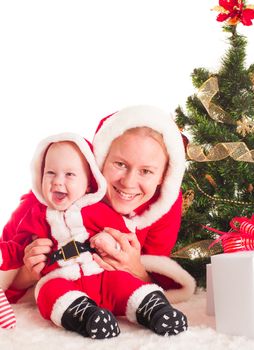 Christmas baby and mom under the fir tree