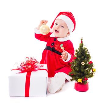 Santa baby girl with gold ball and christmas decorations on white