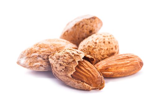 Unpeeled almond heap isolated on white background