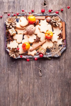 Christmas sweet decor - cookies, apple and spices on the tray