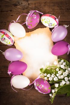 Purple and white eggs and empty greeting card. Easter decorations