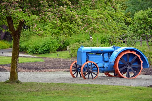 Old blue and orange tractor on display on farm