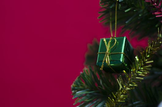 close up green gift christmas on red background