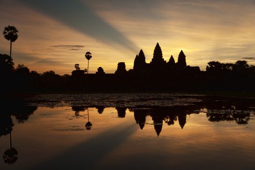 Beautiful sunrise over  Angkor Wat temple. Angkor Wat close to Siem Reap in Cambodia is the largest religious monument in the world built early 12th century.