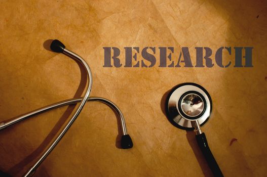 Research typescript next to a stethoscope