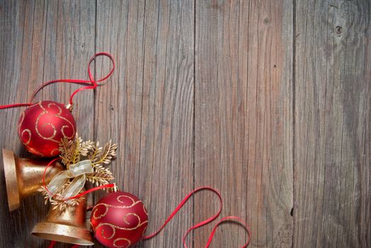 Christmas baubles with a red ribbon frame on a wood texture