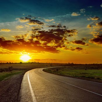 low orange sun over asphalt road