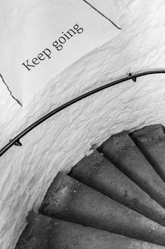 Motivational encouraging sign on the stairs - Keep going, monochrome