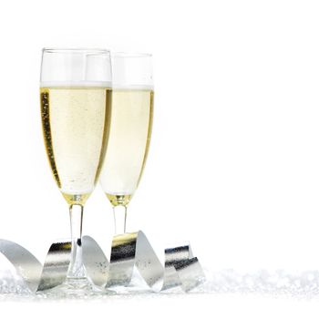 Two champagne flutes and decoration on gold shiny background