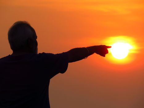 A metaphorical image showing a wide old Indian man pointing at the Sun, showing the concept of a pathfinder or leader.                               