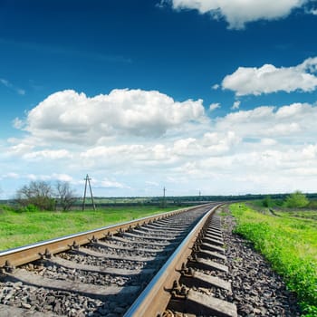 low view to railroad under cloudy sky