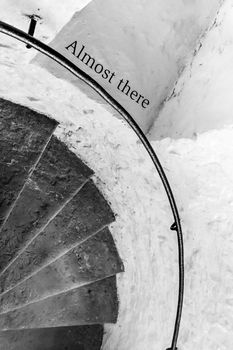 Motivational encouraging sign on the stairs - Almost there, monochrome