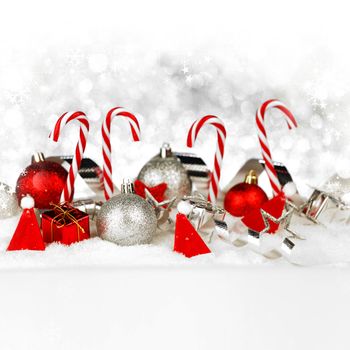 Christmas card with candies and decoration in snow