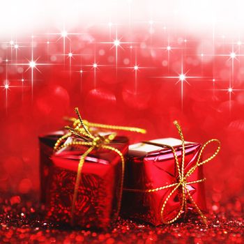 Holiday gifts over shiny glitter background with stars