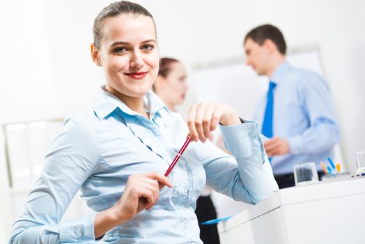 portrait of a business woman in office, smiling and looking into the camera, office work