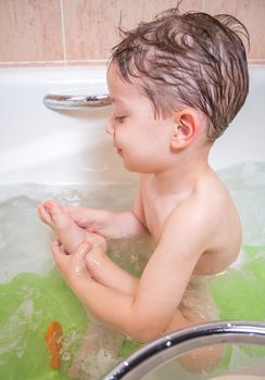 Cute boy happiness having bath in a bathtub