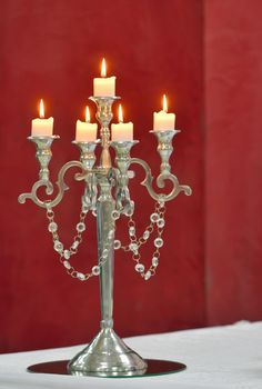 Formal silver candle holder with yellow candles