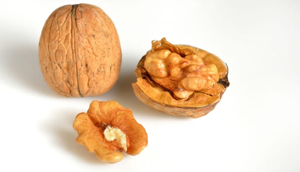 walnut and a cracked walnut isolated on the white background