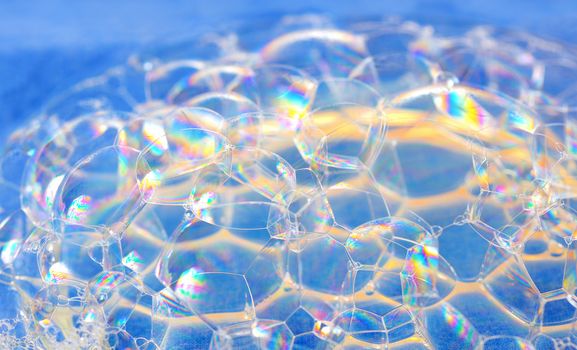 bright soap bubbles on blue background