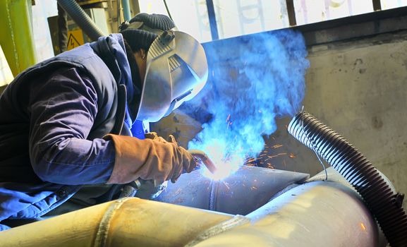 a welder working at shipyard in day time