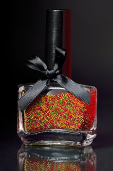 balls nail polish bottle on black background