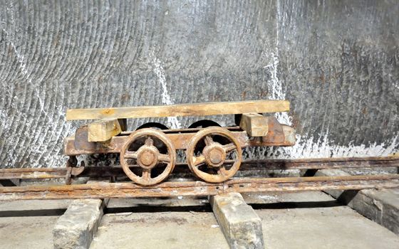 old  wagon inside of salt mine on rail