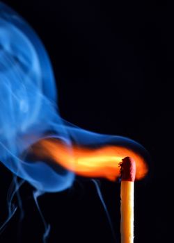 lighting a match on black background