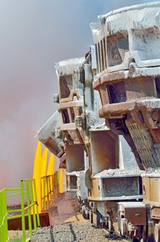 The molten slag is poured from a cup on a railway platform