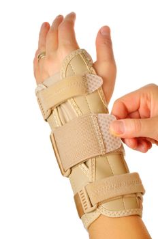 hand with a orthopedic wrist stabilizer over white background