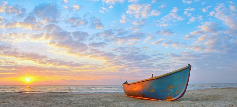 Fishing boat and sunrise on Black Sea beach