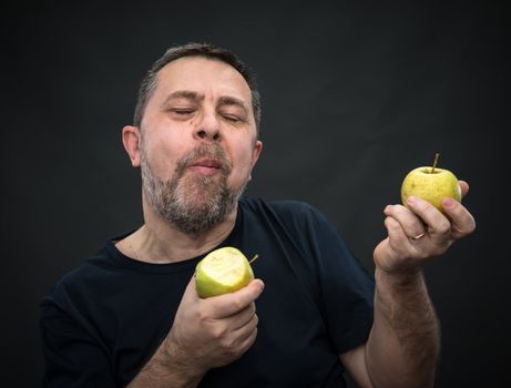 Portrait of a middle-aged man with a green apples