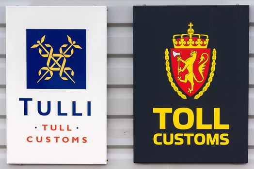 The Finnish sign is the left one, the Norwegian the right one. Both show the official logo or coat of arms of the country.